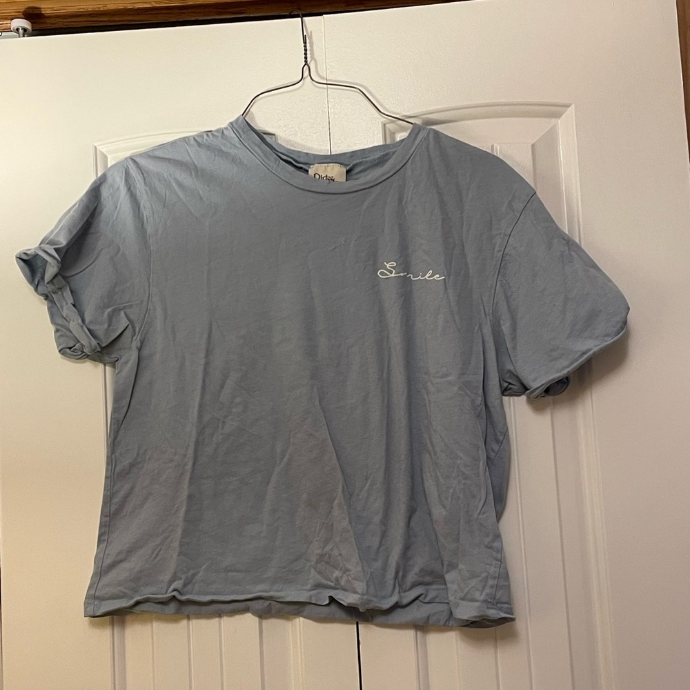 Light blue smile tee shirt. Size XL fits a medium.